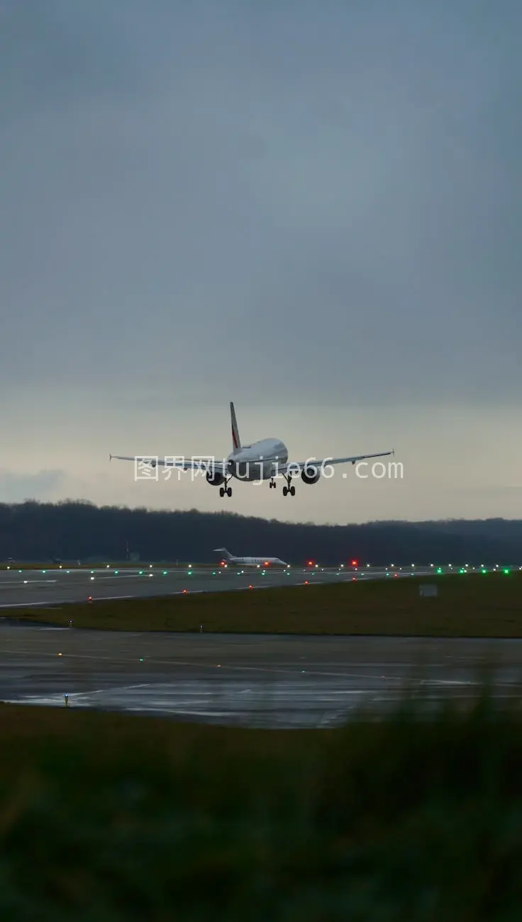 黄昏飞机降落跑道引导灯映衬航空魅力图片