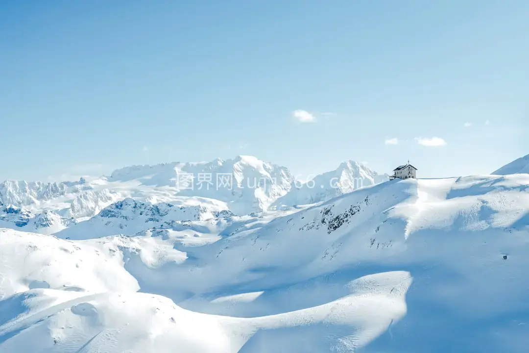 雪山之巅房屋映照日出时分图片