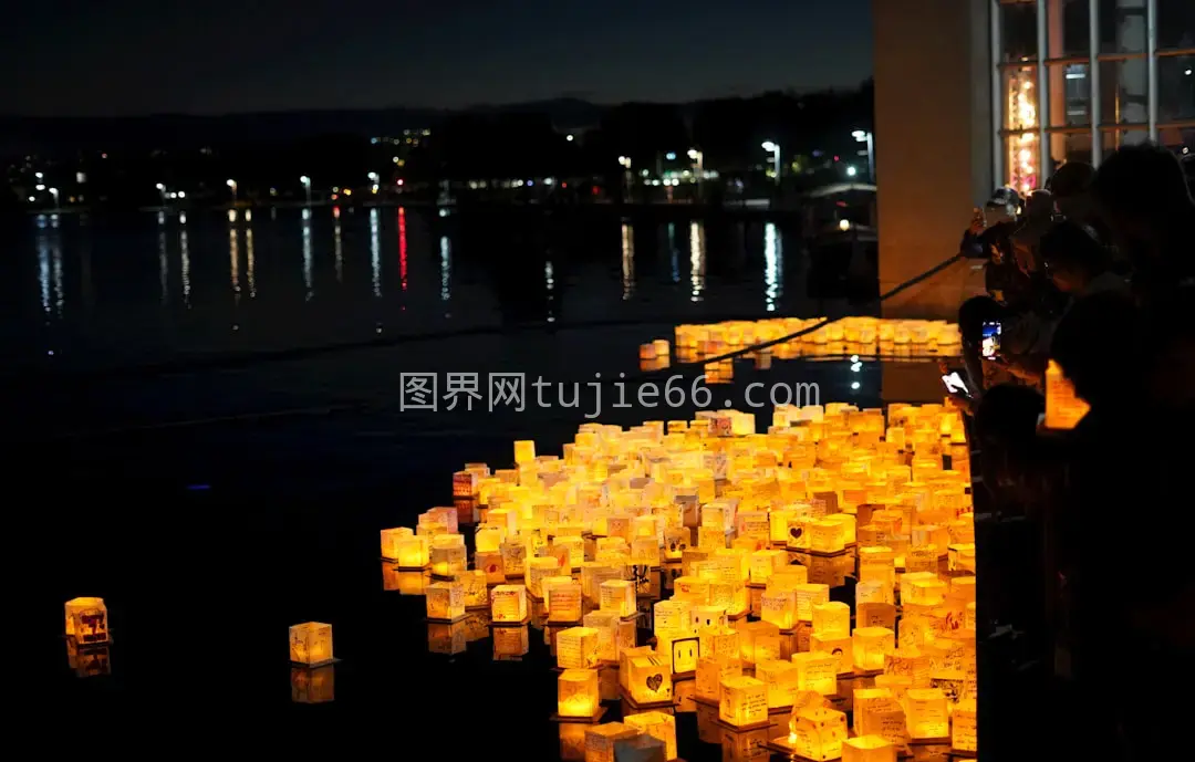 人群蜡烛旁站立夜色图片