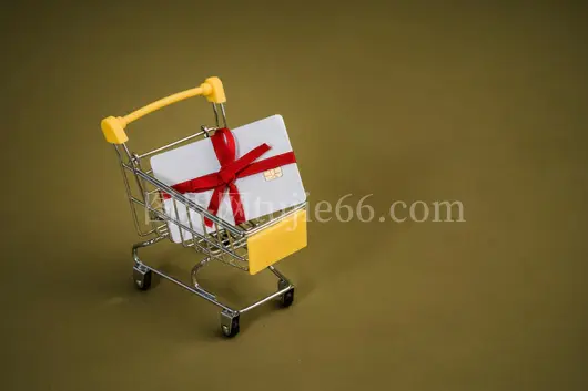 红色蝴蝶结礼品卡购物车映黄背景