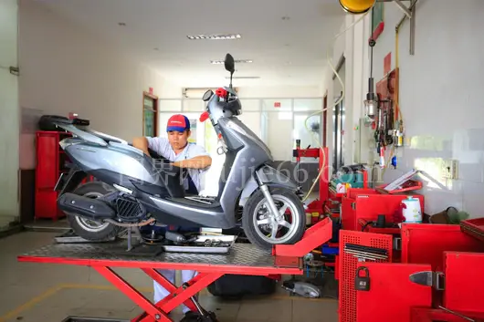 维修师傅室内保养踏板车