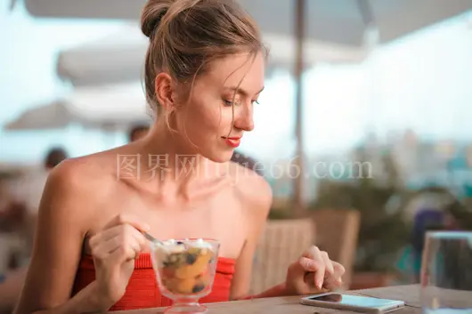 红裙少女户外品果甜，手机相伴