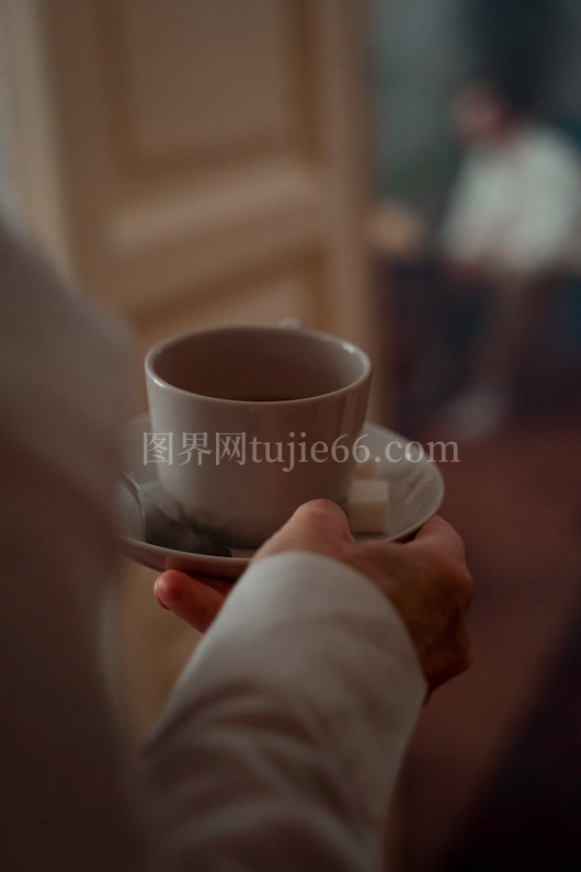 手捧糖茶杯温馨室内景